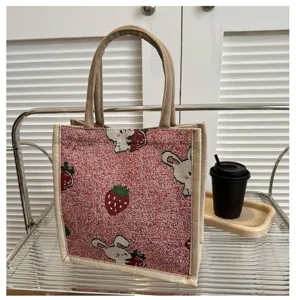 Canvas tote bag with cute strawberry and rabbit print, durable cotton linen handbag for daily use.