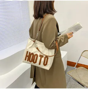 Chic women's tote bag with letter print, versatile large capacity shoulder bag for daily use.