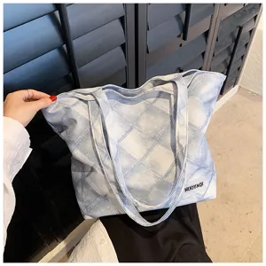 Close-up detail of large capacity casual denim pattern tote bag with double handles.