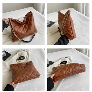 Detail view of brown quilted chain shoulder bag, large capacity slouchy design with gold hardware.