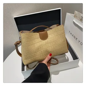 Detailed view of fashionable women crocodile pattern shoulder bag with top handle and chic design.