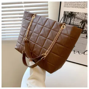 Detailed view of the stylish brown quilted shoulder bag with elegant metallic chain strap.