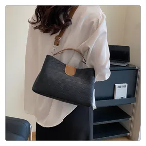 Stylish black PU leather shoulder bag for women, casual crossbody handbag with brown strap.