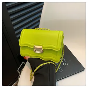 Lime green wave flap shoulder bag with metal chain strap and stylish clasp closure detail.