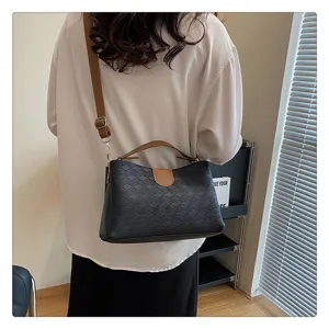 Detailed view of the stylish PU leather geometric patterned crossbody and shoulder handbag.