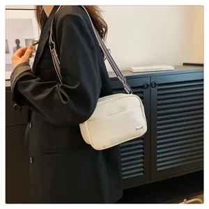 Chic minimalist PU leather crossbody shoulder bag for women featuring a wide striped strap.