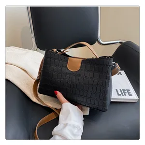 Black crocodile pattern handbag for women, elegant top handle tote and shoulder crossbody bag design.