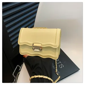 Yellow quilted chain crossbody bag detail view, stylish women's shoulder bag with wave edge.