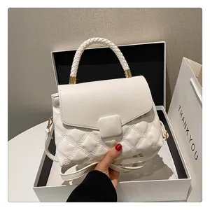 White quilted flap handbag detail, chic braided top handle and crossbody strap design.