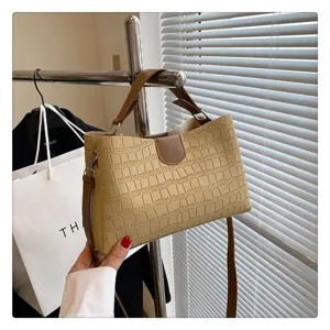 Beige crocodile pattern handbag, detail view of stylish PU leather shoulder and crossbody bag.