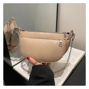 Beige PU leather multi-pocket saddle shoulder bag detail showcasing chain strap and zipper.