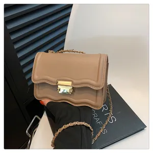 Elegant wavy chain small square bag with metallic lock detail for women's daily fashion.