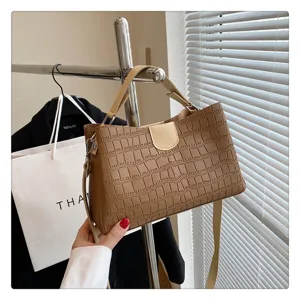 Women brown crocodile pattern handbag tote bag detail view, stylish autumn shoulder bag.