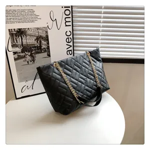 Black quilted tote bag with gold chain strap, stylish design for women's daily wear.