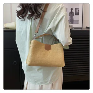 Detailed view of women fashion PU leather shoulder bag featuring textured geometric pattern.