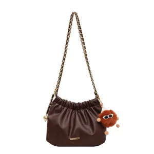 Brown PU leather shoulder bag with chain strap and cute plush pendant for daily women style.