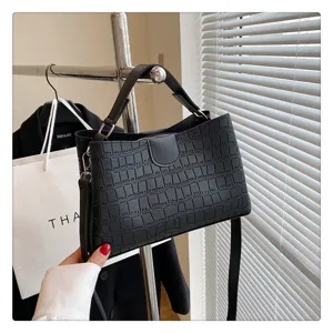 Detailed view of the black crocodile pattern handbag, stylish crossbody and shoulder bag.