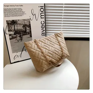 Beige quilted tote bag with gold chain strap, stylish design for daily women use.