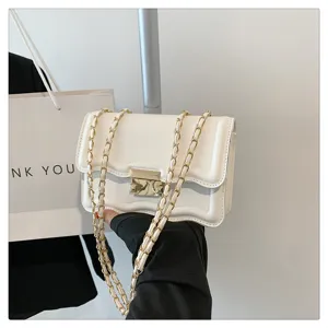 White wavy chain crossbody bag with gold hardware and chic flap design for women daily use.