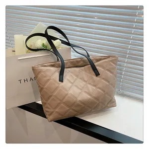 Beige quilted tote bag for women, large capacity casual shoulder bag with black handles.