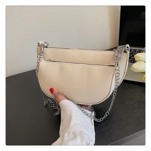 Retro cream white saddle bag for women, stylish underarm shoulder bag with metal chain strap.