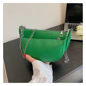 Green leather underarm shoulder bag with silver chain detail for women fashion style.