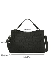 Detailed view of black crocodile pattern women handbag, elegant top handle shoulder bag.