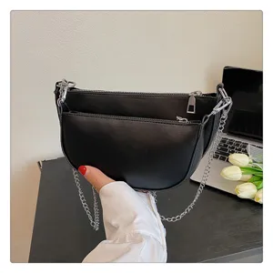 Black PU leather crescent shoulder bag with metallic chain strap and double zipper comp.