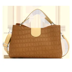 Stylish brown crocodile pattern leather handbag with beige top handle and shoulder strap.
