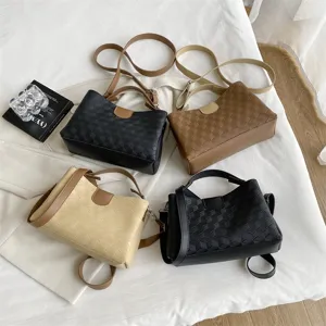 Detailed view of stylish woven PU leather shoulder bags with top handle and crossbody strap.