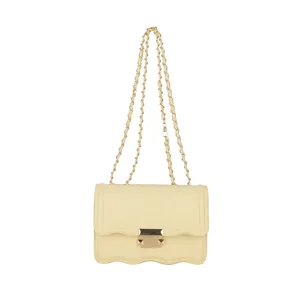 Stylish yellow chain shoulder bag with elegant wavy flap and metal lock for women.