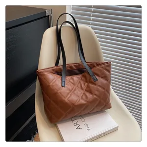 Brown quilted tote bag scene detail showing modern chair and elegant design aesthetics.