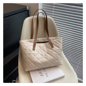 Quilted tote bag detail view, casual shoulder bag with diamond stitching and contrast straps.