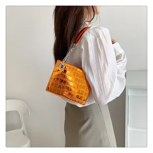 Detail shot of stylish orange metallic crocodile pattern women chain shoulder bag, fashion daily use