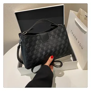 Stylish black PU leather handbag with geometric texture, top handle and shoulder strap.