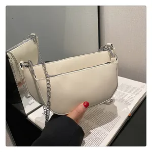 Chic white crescent shoulder bag for women, trendy PU leather hobo bag with stylish silver chain.