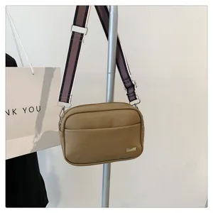 Chic PU leather crossbody bag for women with wide striped strap and simple square design.