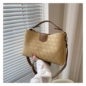 Detailed view of the stylish PU leather handbag with geometric texture and brown straps.
