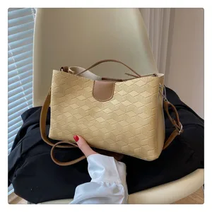 Detailed view of the stylish geometric pattern PU leather handbag with brown accent straps.