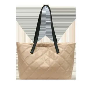 Chic quilted tote bag for women, large capacity shoulder bag with stylish black handles.