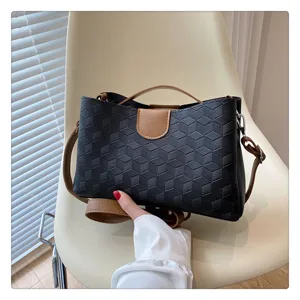 Closeup detail view highlighting the elegant black geometric textured PU leather crossbody bag.