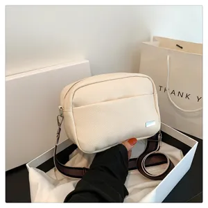 Women's PU leather crossbody bag with wide strap, simple casual shoulder bag detail view.