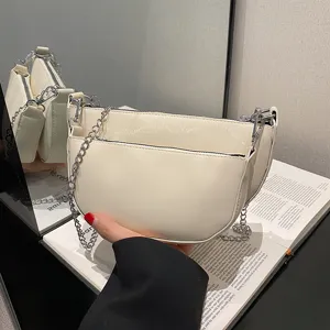 Elegant white patent leather crescent underarm shoulder bag with silver chain strap