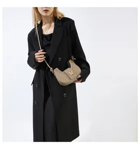 Trendy chic niche design women shoulder armpit bag with elegant butterfly metal decor.