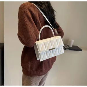 White quilted crossbody bag with top handle and stylish diamond pattern for daily use
