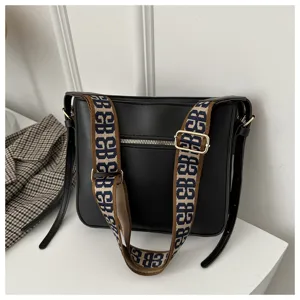 Black commuting large-capacity shoulder bag with wide monogram strap and metal hardware.