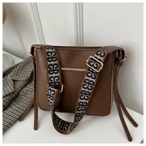 Brown PU leather shoulder bag detail, stylish wide monogram strap and metal zipper.