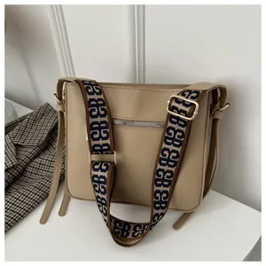Khaki shoulder bag for women with wide monogram strap, stylish casual crossbody design.