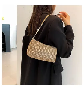 Stylish gold rhinestone shoulder bag with pearl chain detail, elegant women baguette handbag.