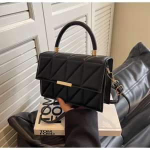 Elegant black quilted square crossbody bag with top handle and metallic clasp detail.